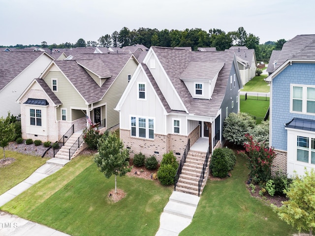 2837 Milano Ave, Apex, NC 27502 - view of front of house featuring stairs, board and batten siding, a front lawn, brick siding, and a residential view
