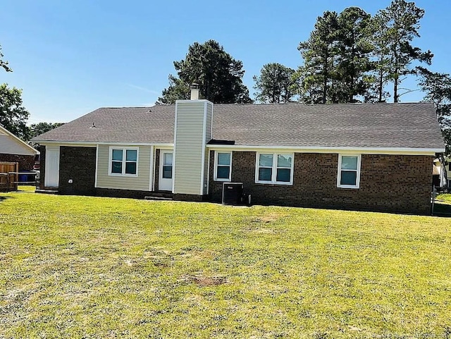 7690 Beverly Dr, Fayetteville, NC 28314 - rear view of house with a chimney and brick siding