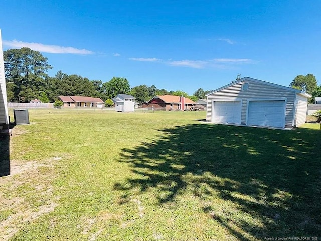 7690 Beverly Dr, Fayetteville, NC 28314 - view of yard featuring an outbuilding, a detached garage, and central air condition unit