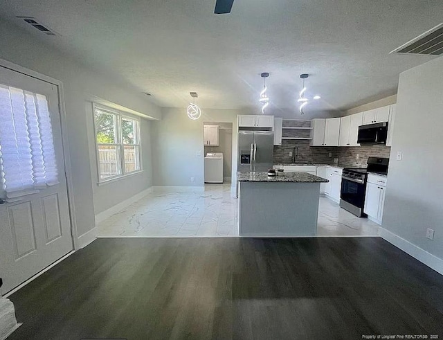 7690 Beverly Dr, Fayetteville, NC 28314 - kitchen featuring range with electric cooktop, stainless steel refrigerator with ice dispenser, washer / dryer, a sink, and black microwave