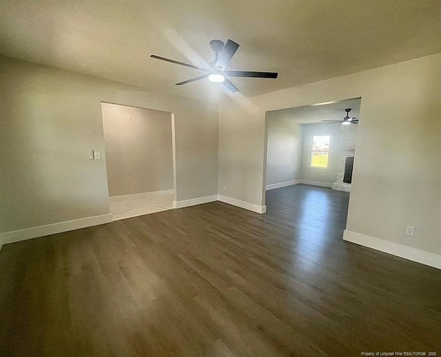 7690 Beverly Dr, Fayetteville, NC 28314 - spare room with ceiling fan, dark wood-type flooring, baseboards, and a fireplace