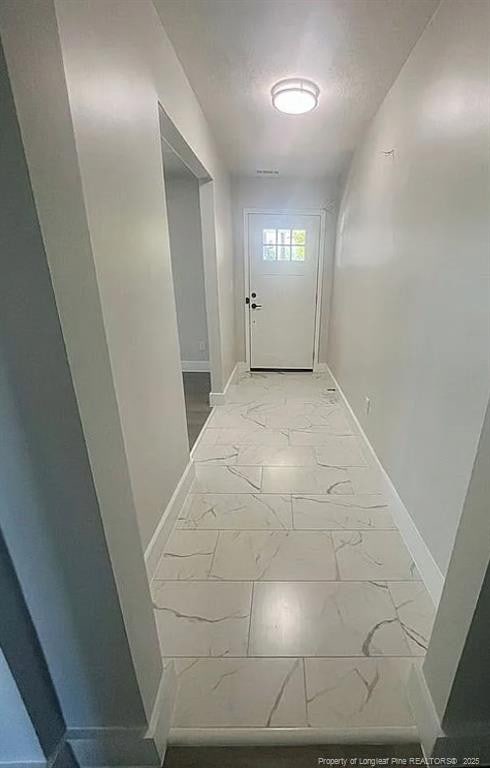 7690 Beverly Dr, Fayetteville, NC 28314 - doorway with baseboards and light marble finish flooring