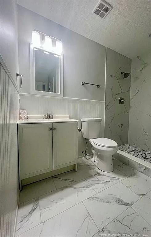 7690 Beverly Dr, Fayetteville, NC 28314 - full bath featuring marble finish flooring, a walk in shower, vanity, toilet, and a wainscoted wall