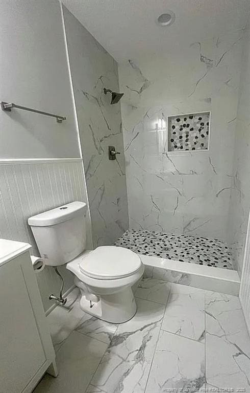7690 Beverly Dr, Fayetteville, NC 28314 - full bath with toilet, marble finish floors, a wainscoted wall, and a marble finish shower