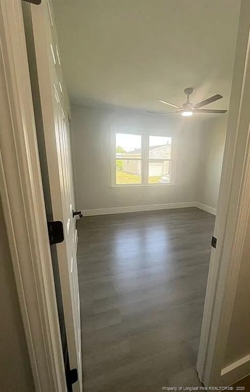 7690 Beverly Dr, Fayetteville, NC 28314 - unfurnished room with baseboards, dark wood-style floors, and a ceiling fan