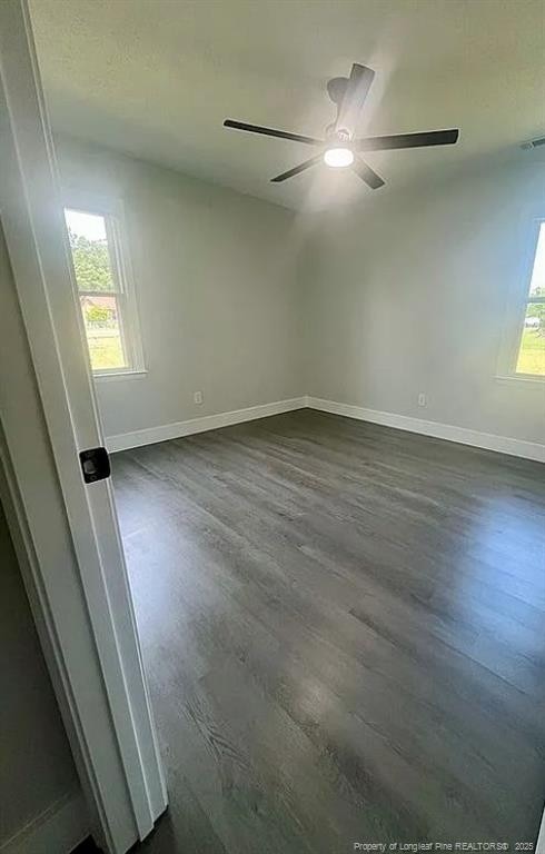 7690 Beverly Dr, Fayetteville, NC 28314 - unfurnished room with dark wood-type flooring, ceiling fan, and baseboards