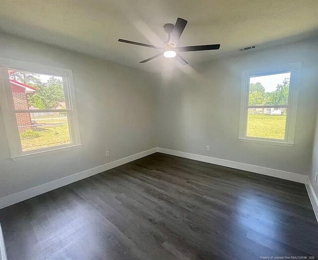 7690 Beverly Dr, Fayetteville, NC 28314 - spare room featuring dark wood-style flooring, baseboards, and a ceiling fan