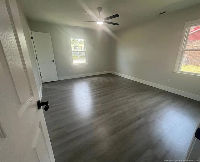 7690 Beverly Dr, Fayetteville, NC 28314 - spare room featuring dark wood-style floors, ceiling fan, and baseboards