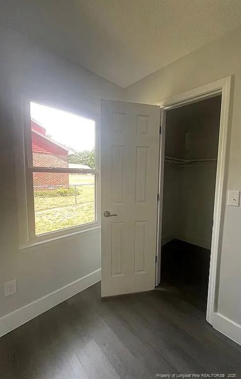 7690 Beverly Dr, Fayetteville, NC 28314 - unfurnished bedroom with dark wood-style flooring, baseboards, and a closet