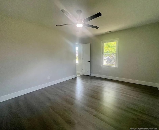 7690 Beverly Dr, Fayetteville, NC 28314 - empty room with baseboards, dark wood-type flooring, and a ceiling fan