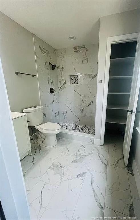 7690 Beverly Dr, Fayetteville, NC 28314 - bathroom featuring a shower stall, toilet, marble finish flooring, and vanity