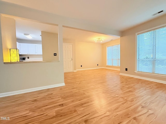 4120 Sedgewood Dr Unit 106, Raleigh, NC 27612 - unfurnished living room featuring light wood finished floors and baseboards