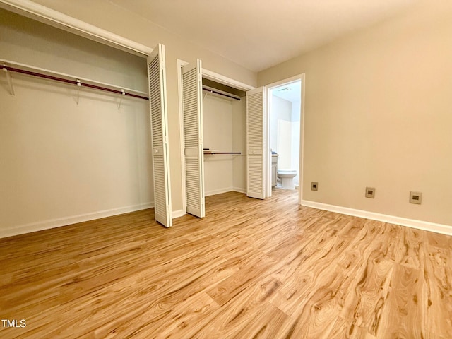 4120 Sedgewood Dr Unit 106, Raleigh, NC 27612 - unfurnished bedroom with two closets, wood finished floors, baseboards, and ensuite bathroom