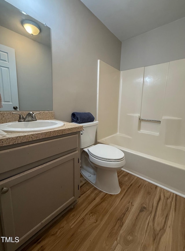 4120 Sedgewood Dr Unit 106, Raleigh, NC 27612 - bathroom featuring wood finished floors, toilet, vanity, and shower / washtub combination
