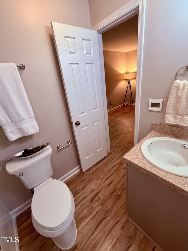 4120 Sedgewood Dr Unit 106, Raleigh, NC 27612 - bathroom with wood finished floors, toilet, vanity, and baseboards