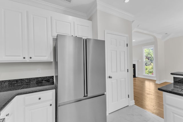 2204 Bellaire Ave, Raleigh, NC 27608 - kitchen featuring freestanding refrigerator, white cabinets, dark stone counters, crown molding, and recessed lighting