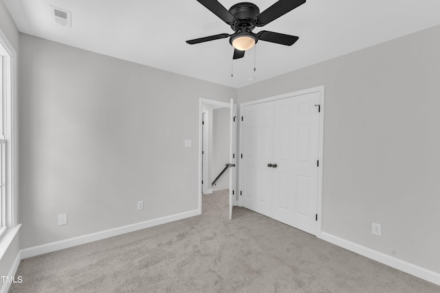 2204 Bellaire Ave, Raleigh, NC 27608 - unfurnished bedroom with carpet, baseboards, a closet, and a ceiling fan