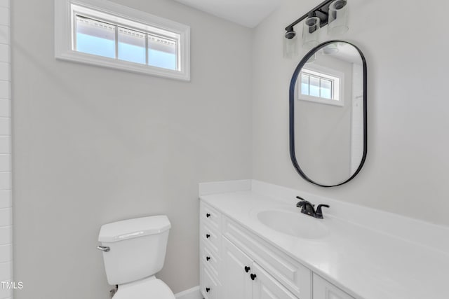 2204 Bellaire Ave, Raleigh, NC 27608 - bathroom with plenty of natural light, toilet, vanity, and baseboards