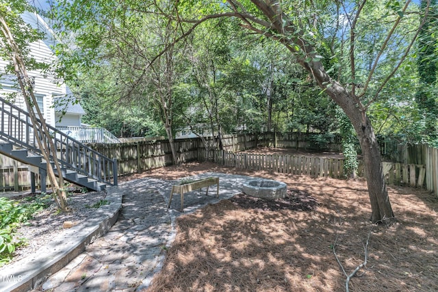2204 Bellaire Ave, Raleigh, NC 27608 - fenced backyard featuring stairway and an outdoor fire pit