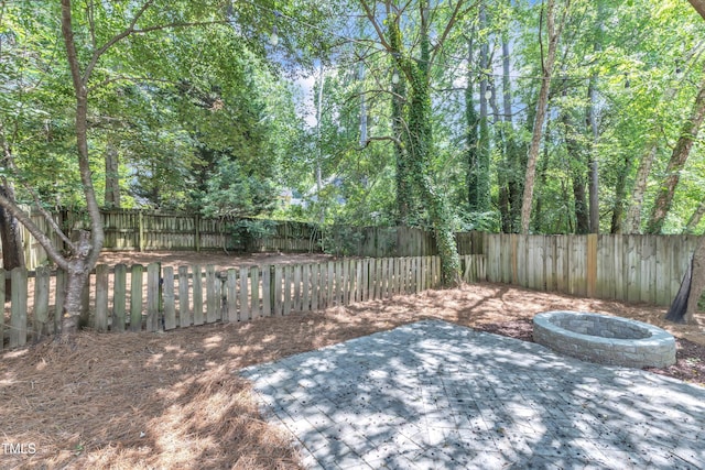 2204 Bellaire Ave, Raleigh, NC 27608 - fenced backyard featuring a patio and an outdoor fire pit