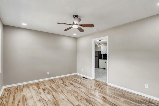 spare room with ceiling fan, light wood-style floors, baseboards, and recessed lighting