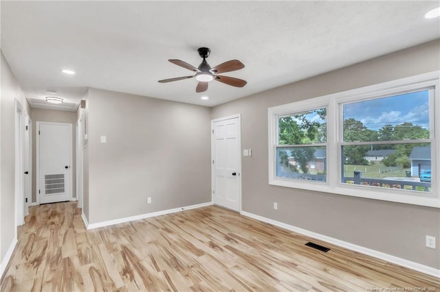 empty room featuring baseboards, light wood finished floors, a ceiling fan, and recessed lighting