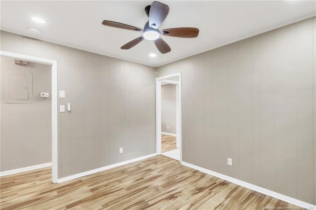spare room featuring light wood-type flooring, ceiling fan, baseboards, and recessed lighting