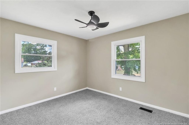 unfurnished room featuring carpet, ceiling fan, and baseboards