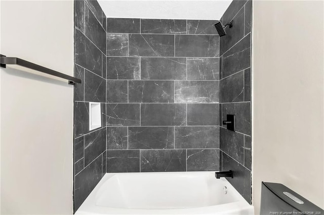 full bathroom featuring tub / shower combination and toilet