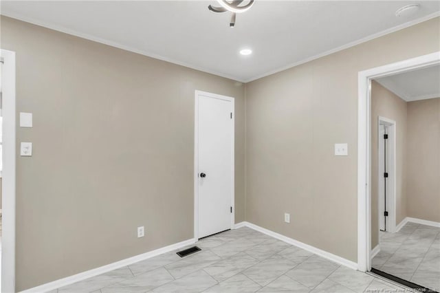 empty room featuring light marble finish flooring, crown molding, baseboards, and recessed lighting