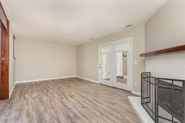 1304 Seaton Rd Unit 1, Durham, NC 27713 - unfurnished living room with light wood-style floors, baseboards, and a fireplace