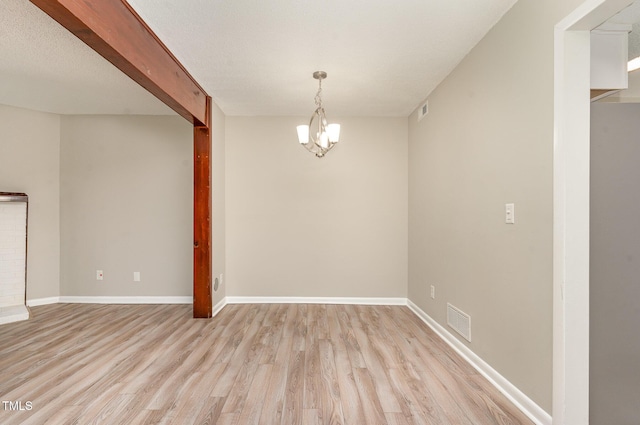 1304 Seaton Rd Unit 1, Durham, NC 27713 - unfurnished dining area with light wood-type flooring, baseboards, and a chandelier