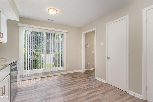 1304 Seaton Rd Unit 1, Durham, NC 27713 - unfurnished dining area featuring light wood-type flooring and baseboards