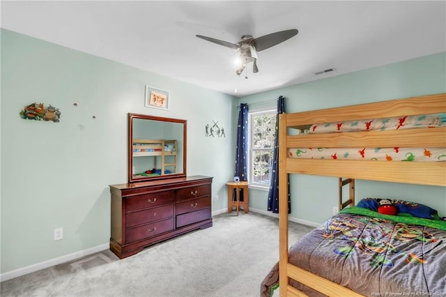 carpeted bedroom featuring baseboards and a ceiling fan