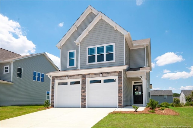 view of front facade with a garage, stone siding, driveway, and a front lawn