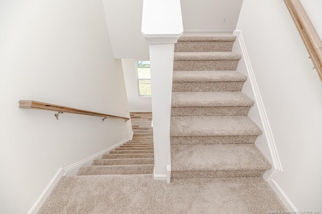 stairs with carpet floors and baseboards