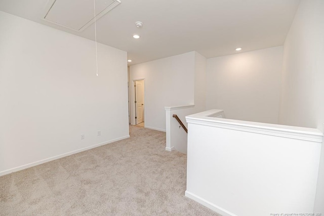 empty room featuring attic access, carpet, baseboards, recessed lighting, and a smoke detector
