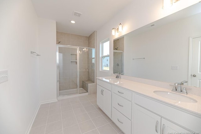 full bath with tile patterned floors, a stall shower, double vanity, baseboards, and recessed lighting