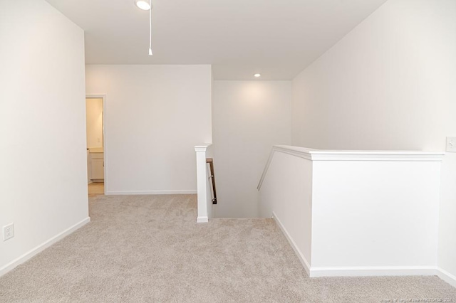 spare room featuring carpet, baseboards, and recessed lighting