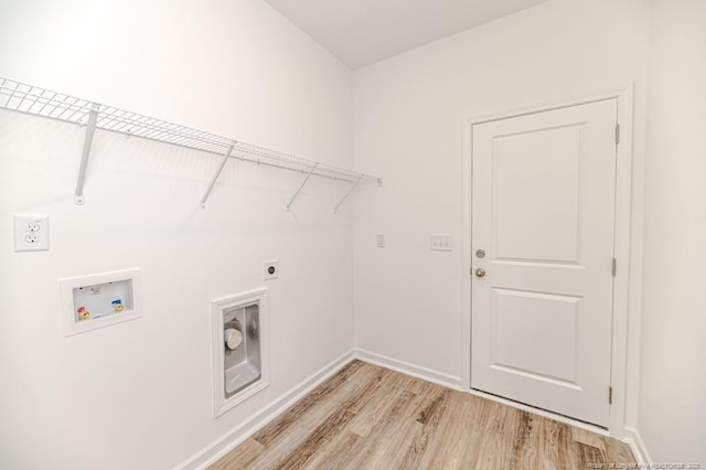 laundry area featuring hookup for a washing machine, light wood finished floors, electric dryer hookup, and baseboards