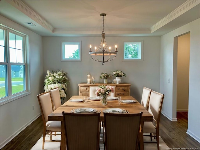 dining area with a chandelier, dark wood finished floors, baseboards, ornamental molding, and a raised ceiling