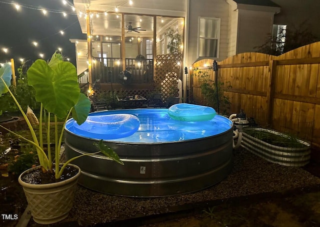 exterior space featuring a sunroom and an outdoor pool
