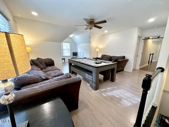 recreation room with light wood-style floors, ceiling fan, vaulted ceiling, baseboards, and recessed lighting