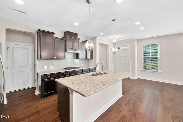 1103 Laurel Twist Rd, Cary, NC 27513 - kitchen featuring a sink, dark brown cabinets, dark wood-style flooring, decorative backsplash, and a kitchen island with sink