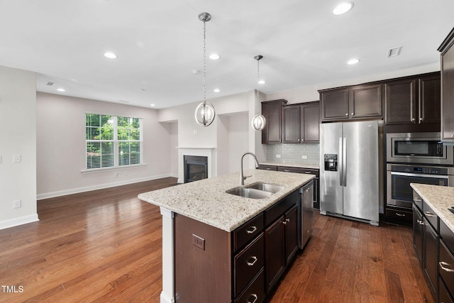 1103 Laurel Twist Rd, Cary, NC 27513 - kitchen with stainless steel appliances, a sink, dark wood-type flooring, decorative backsplash, and recessed lighting