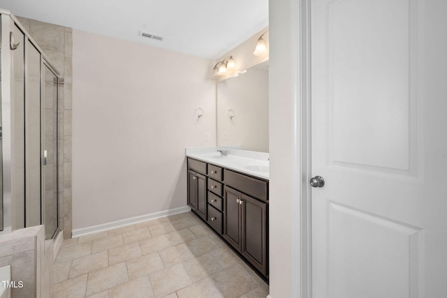 1103 Laurel Twist Rd, Cary, NC 27513 - bathroom featuring double vanity, a stall shower, baseboards, and tile patterned floors