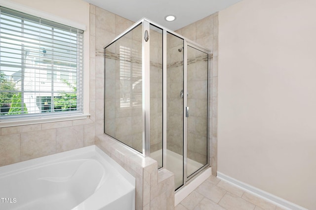 1103 Laurel Twist Rd, Cary, NC 27513 - bathroom featuring a shower stall, a garden tub, tile patterned flooring, and baseboards