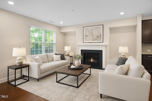 1103 Laurel Twist Rd, Cary, NC 27513 - living area featuring wood finished floors, recessed lighting, a fireplace with flush hearth, and baseboards