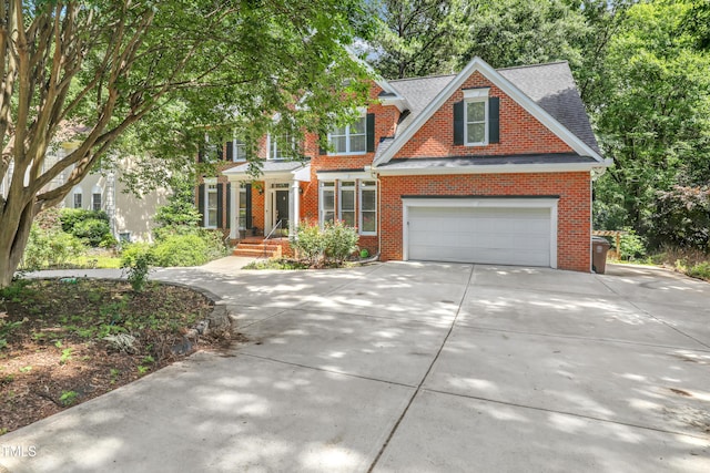 123 W Camden Forest Dr, Cary, NC 27518 - view of front of house with concrete driveway, brick siding, and roof with shingles