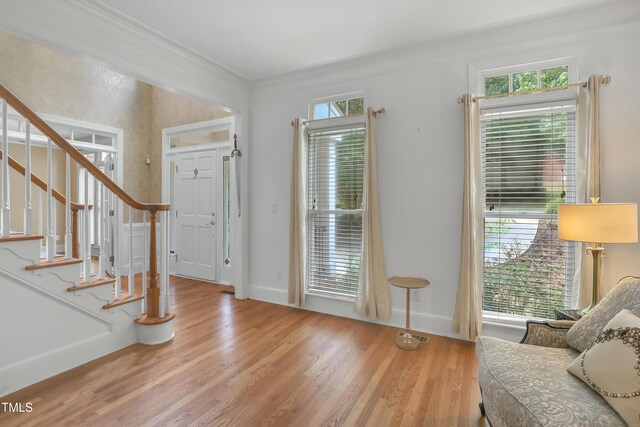 123 W Camden Forest Dr, Cary, NC 27518 - foyer entrance featuring stairs, light wood-type flooring, baseboards, and crown molding